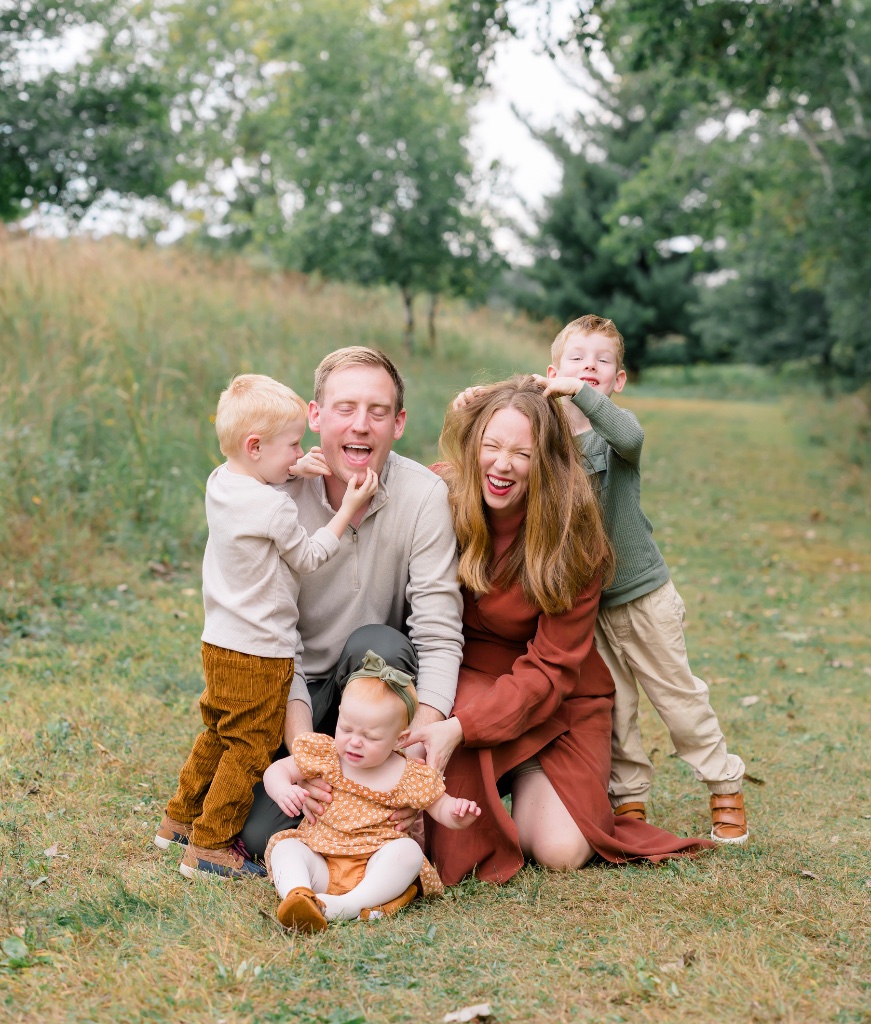 Happy family laughing together outdoors