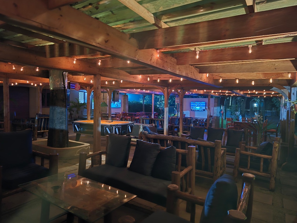 Premium cocktails and beer tower in atmospheric garden bar setting