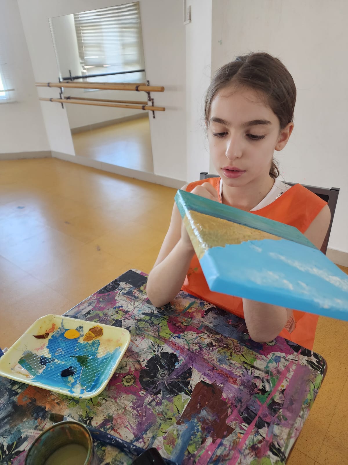Student painting in visual arts class
