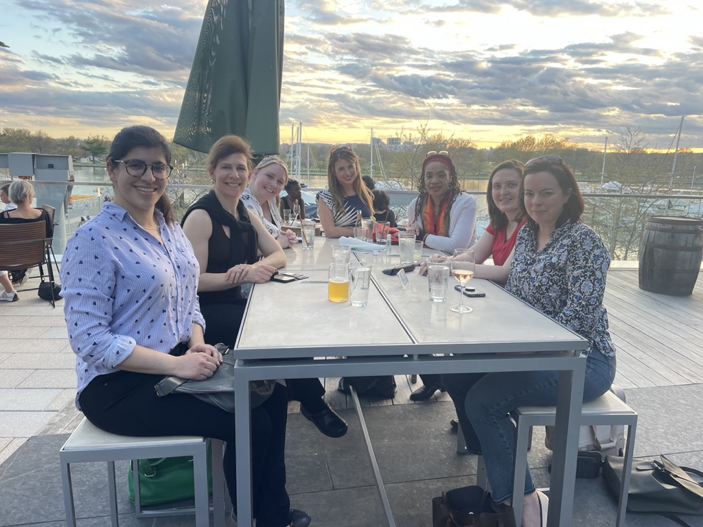 Samantha with program alumni at waterfront dinner