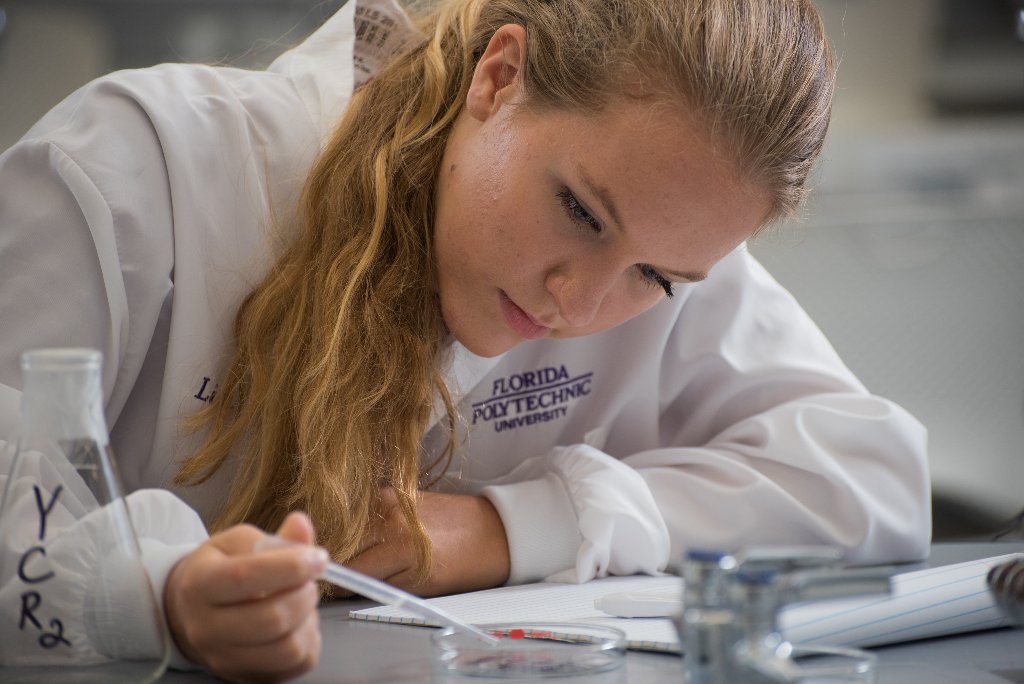 Florida Polytechnic student in lab coat