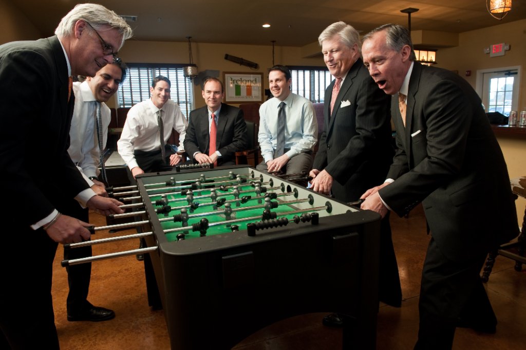 Business team playing foosball