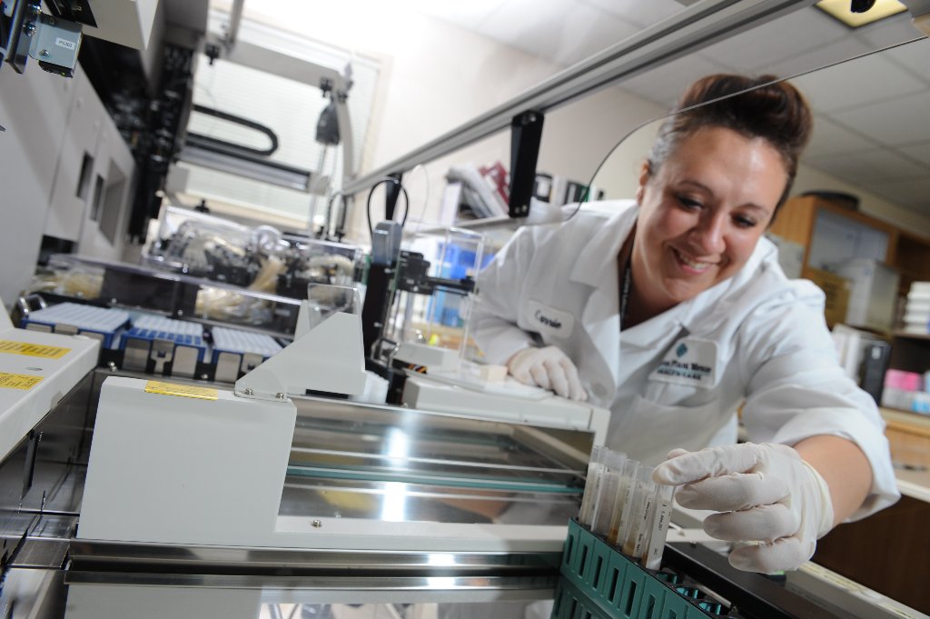 Lab technician loading specimens