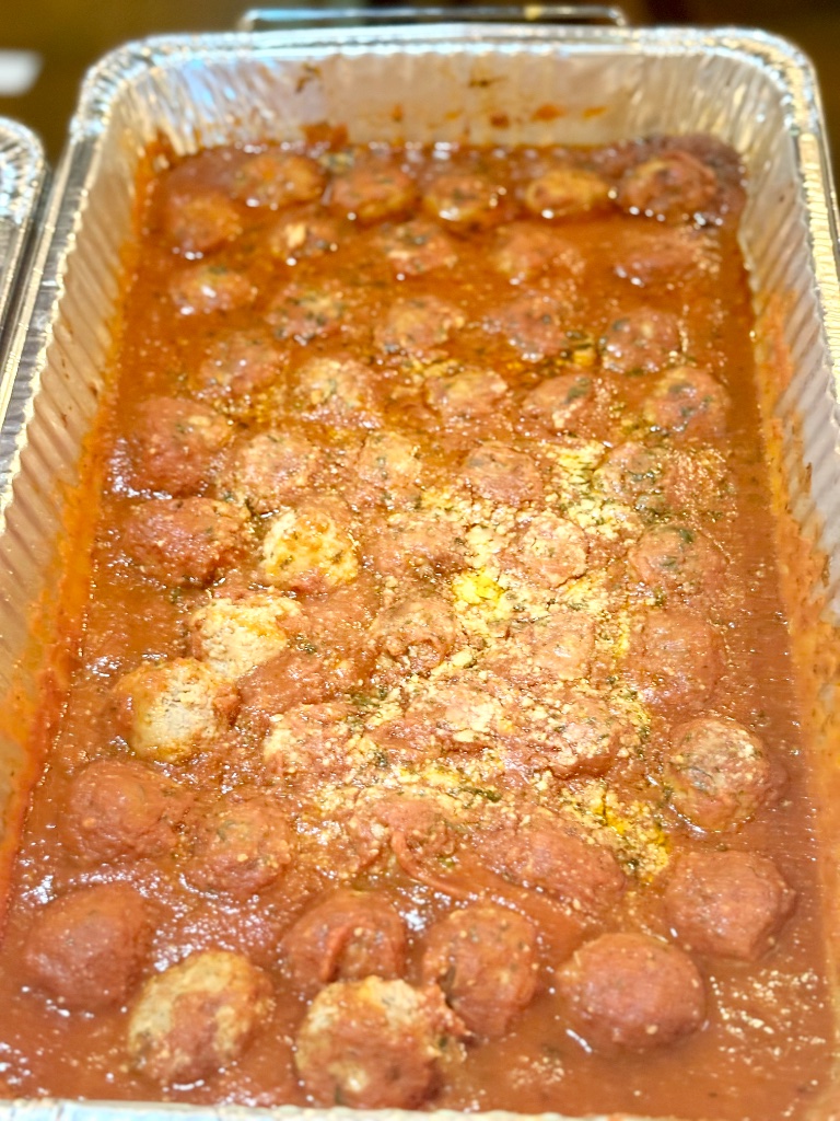 Homemade Italian meatballs simmered in slow-cooked tomato sauce by DiRenzo Brothers Catering in Pittsburgh