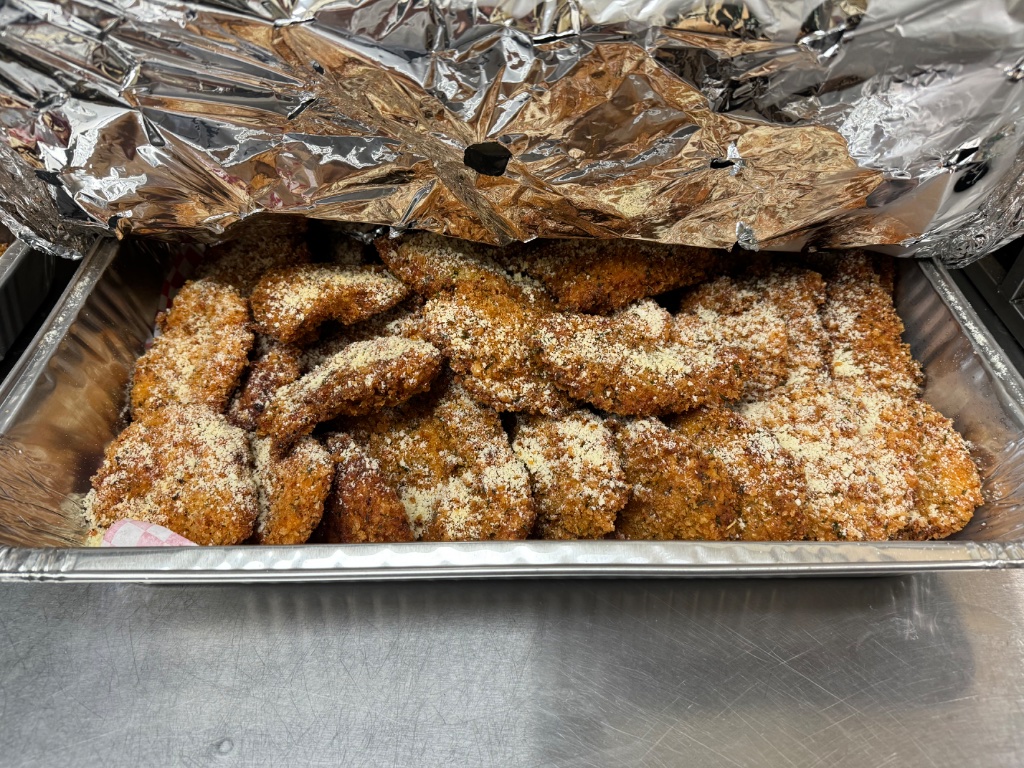 Catering tray of breaded chicken cutlets, a signature Italian dish from DiRenzo Brothers Catering in Pittsburgh