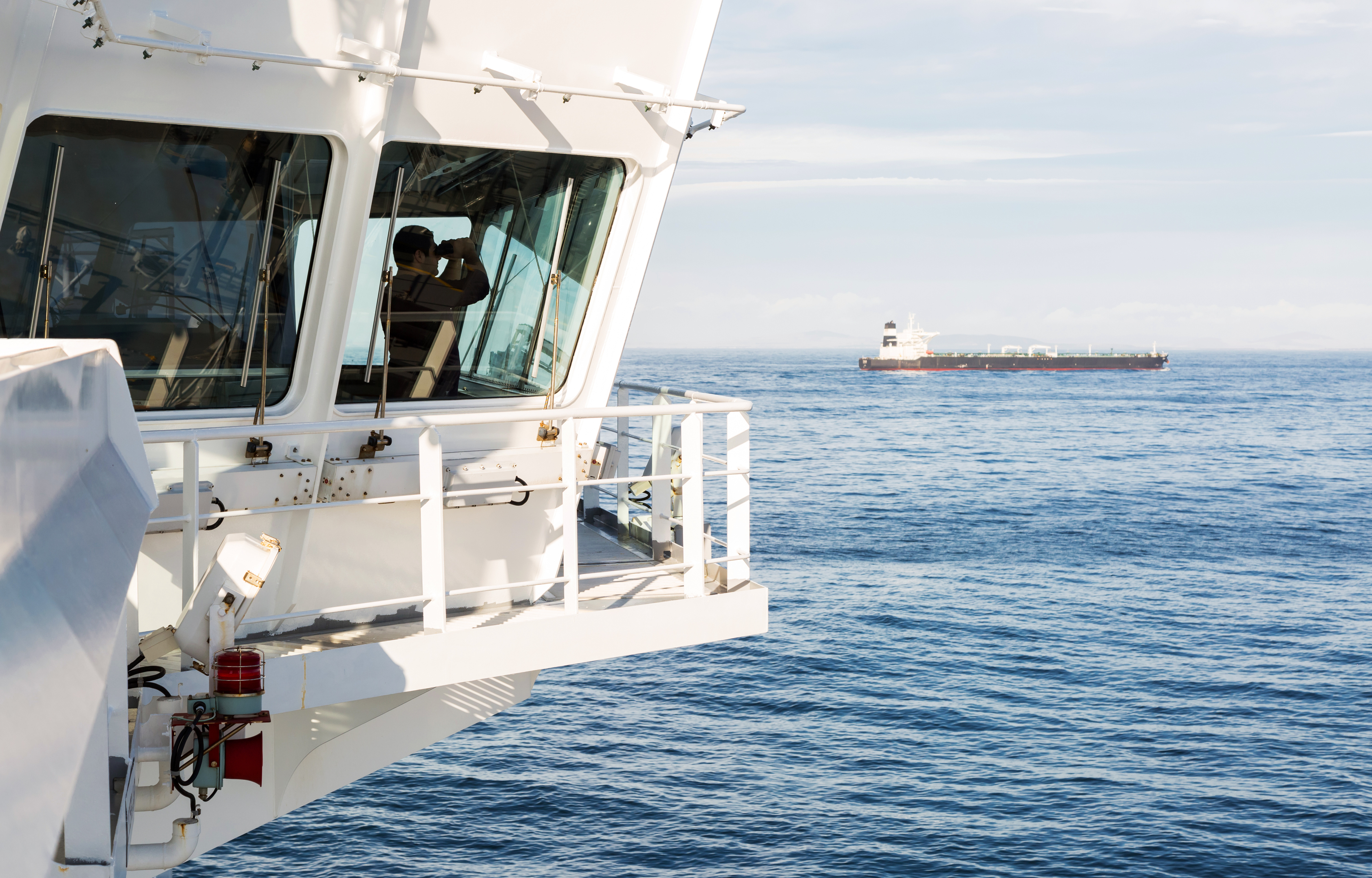 Ship's Master on the bridge overlooking the sea