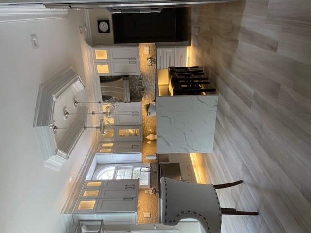 Elegant Kitchen with Coffered Ceiling & Lit Cabinets
