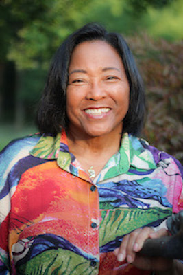 Dr. Debbie with a warm, inviting smile outdoors