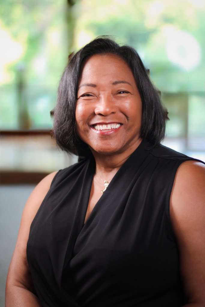 Dr. Debbie Moffatt smiling warmly in a professional portrait