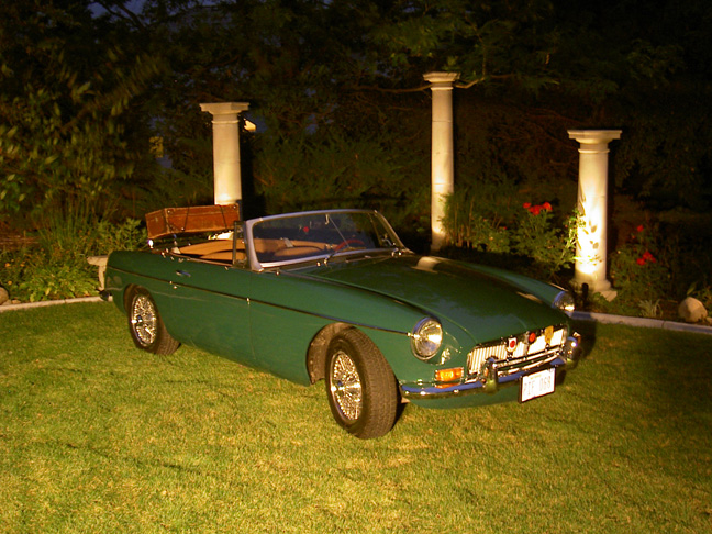 1968 MGB convertible in British racing green parked on a lawn at night