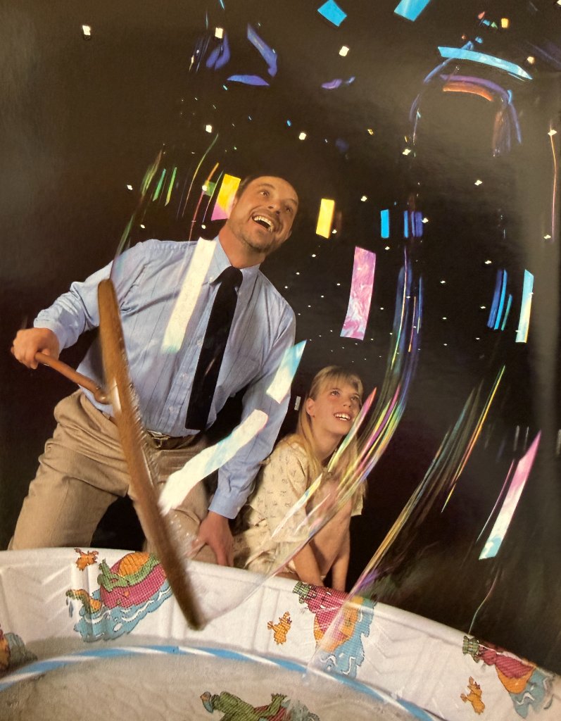 Ron and a young girl enjoying a giant bubble