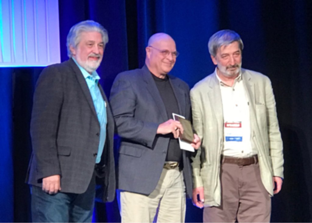 Ron Bonnstetter receiving the Joe Kamiya First Person Science Award on stage with colleagues