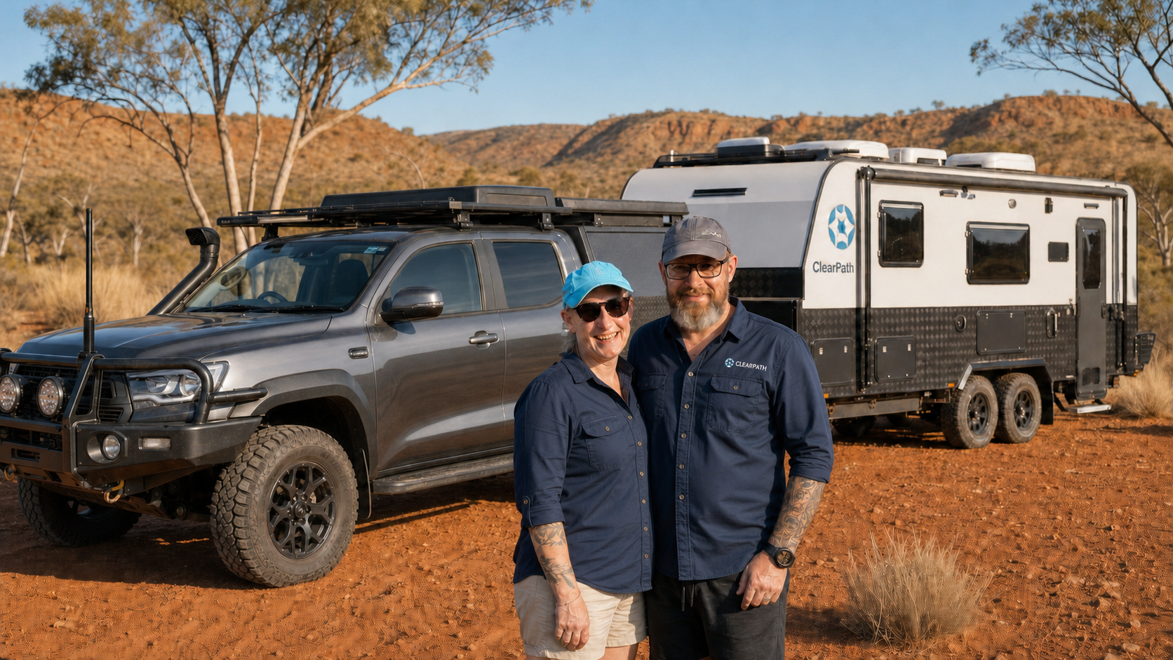 Ian and Sandy Blewitt, ClearPath founders, with a dual-cab 4WD and caravan in outback Australia