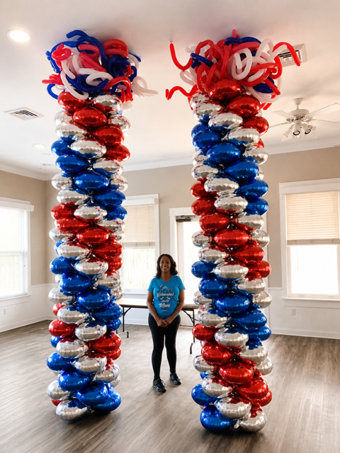 Tall red white and blue balloon columns