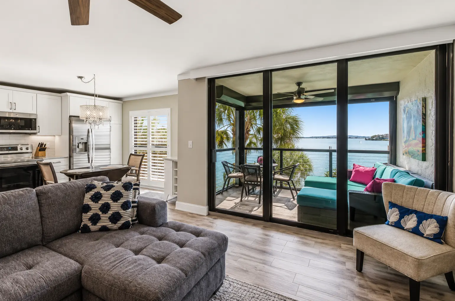 Screened lanai seating with stunning Marco River views at Bottlenose Pointe vacation rental