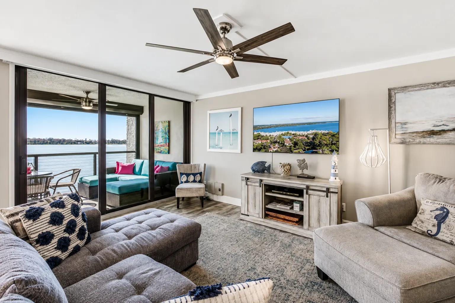 Open-plan living room at Bottlenose Pointe Marco Island vacation rental with river views through triple slider