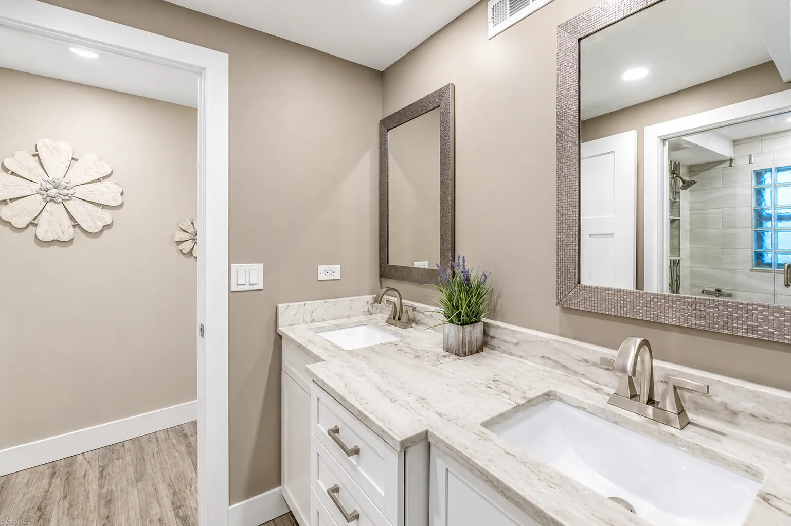 Double vanity bathroom with marble countertops at Bottlenose Pointe luxury vacation rental Marco Island