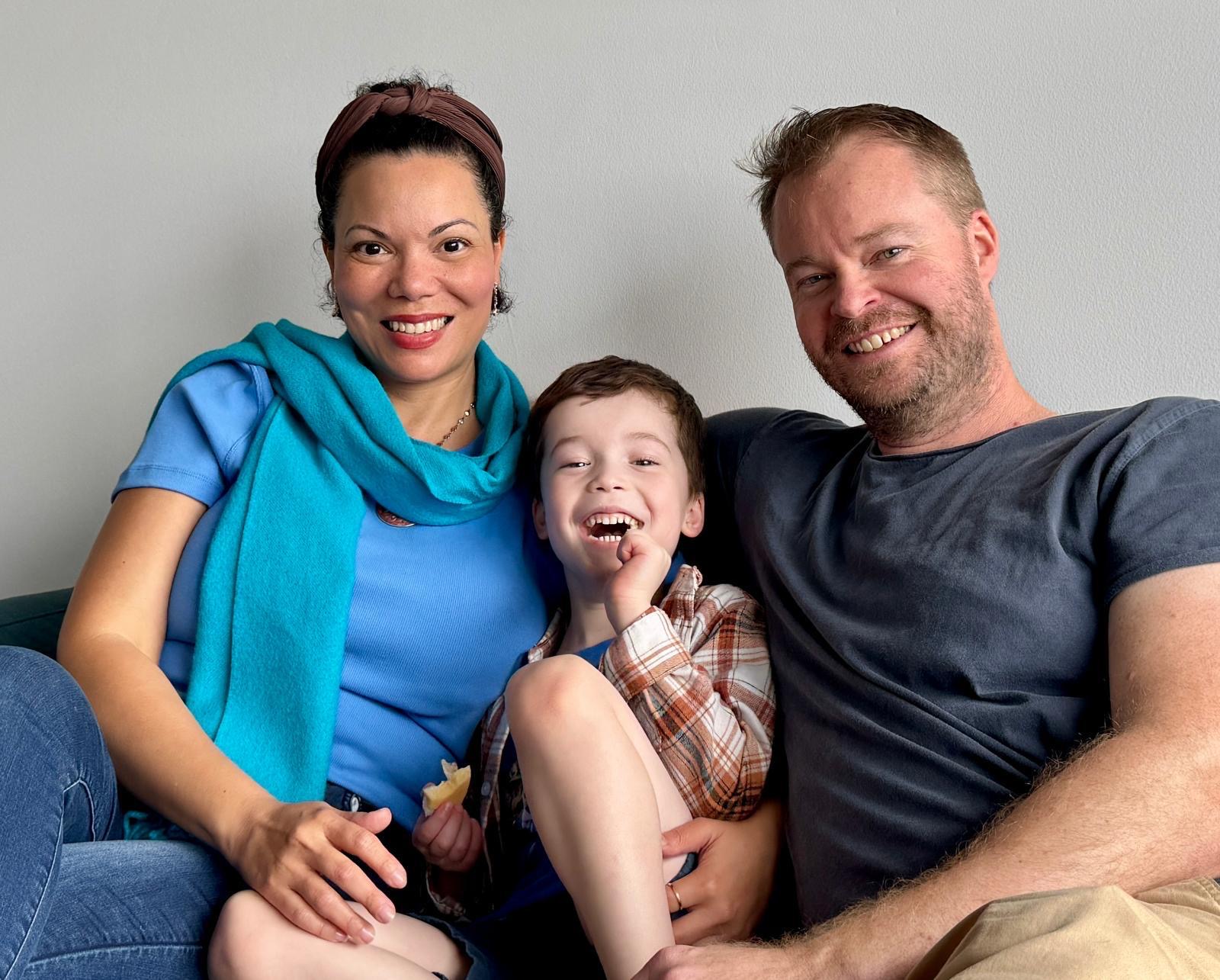 Maria with her partner and son on the couch