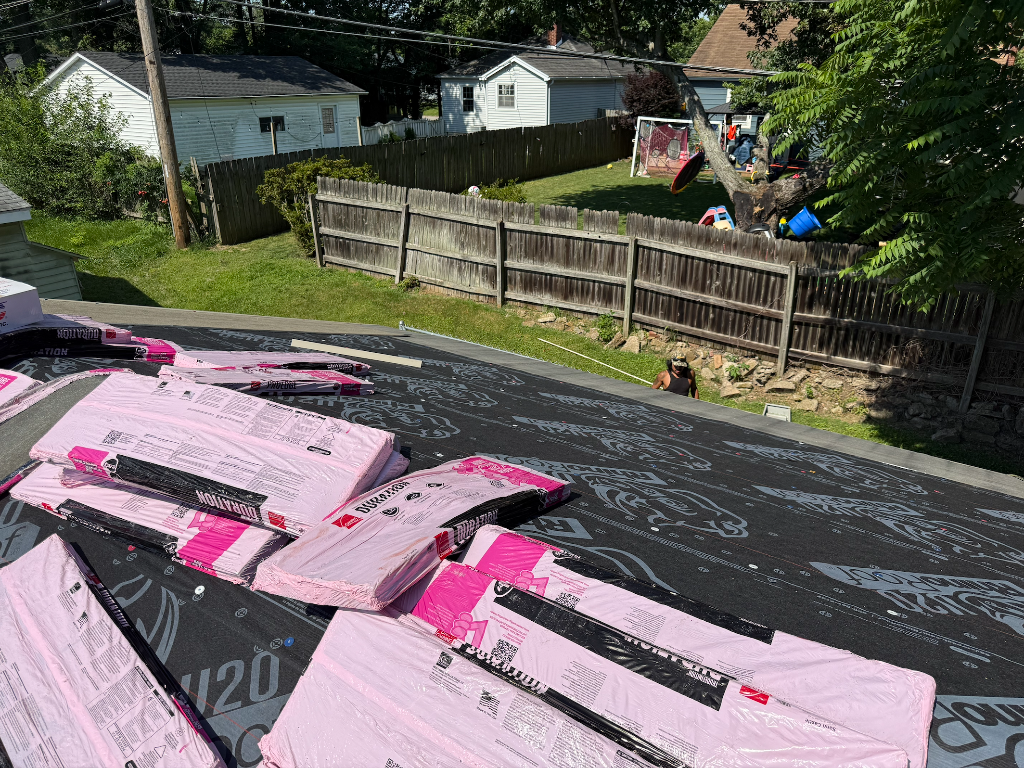 Completed residential roofing project with landscaping