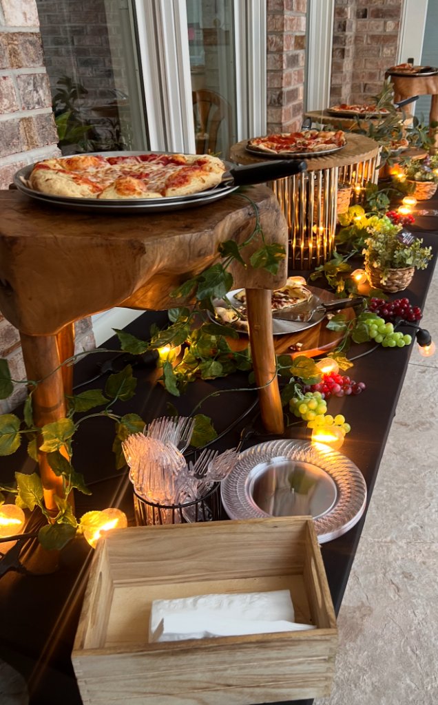 Wood-fired pizza catering setup with candles