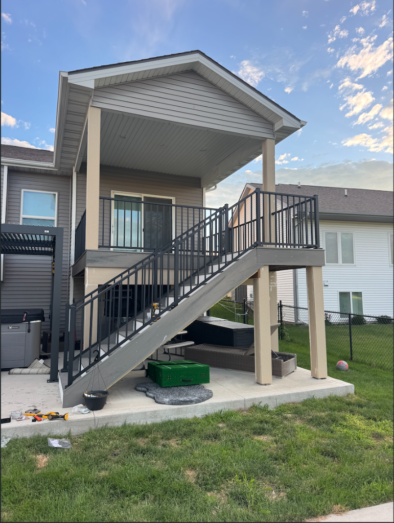 After - Elevated TimberTech Prime+ composite deck with staircase and Westbury aluminum railing built by Akin Brothers deck builders in North Ankeny, Iowa