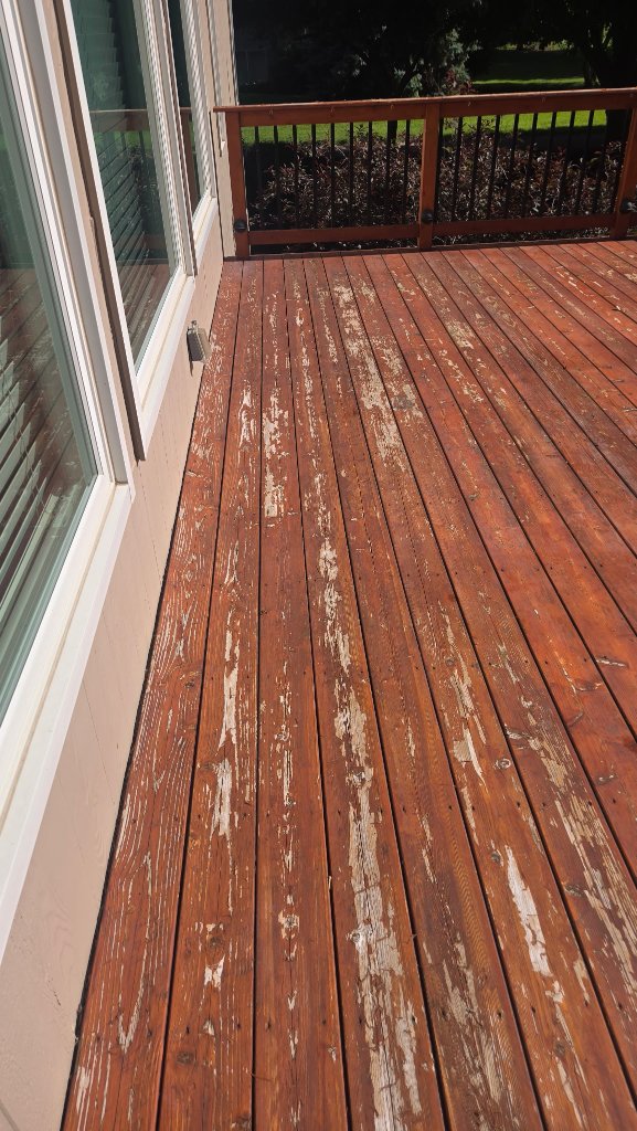 Before - Peeling and weathered deck stain on an old wood deck, before Akin Brothers deck builders refinished it in Central Iowa