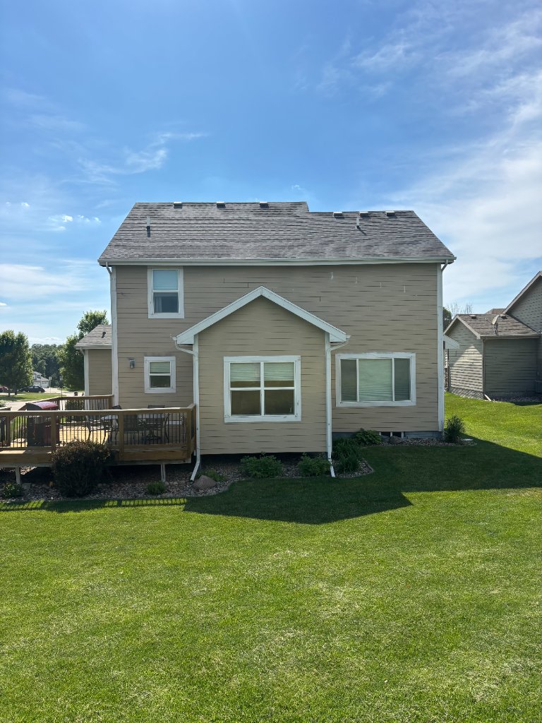 After - Back of home with new siding and deck