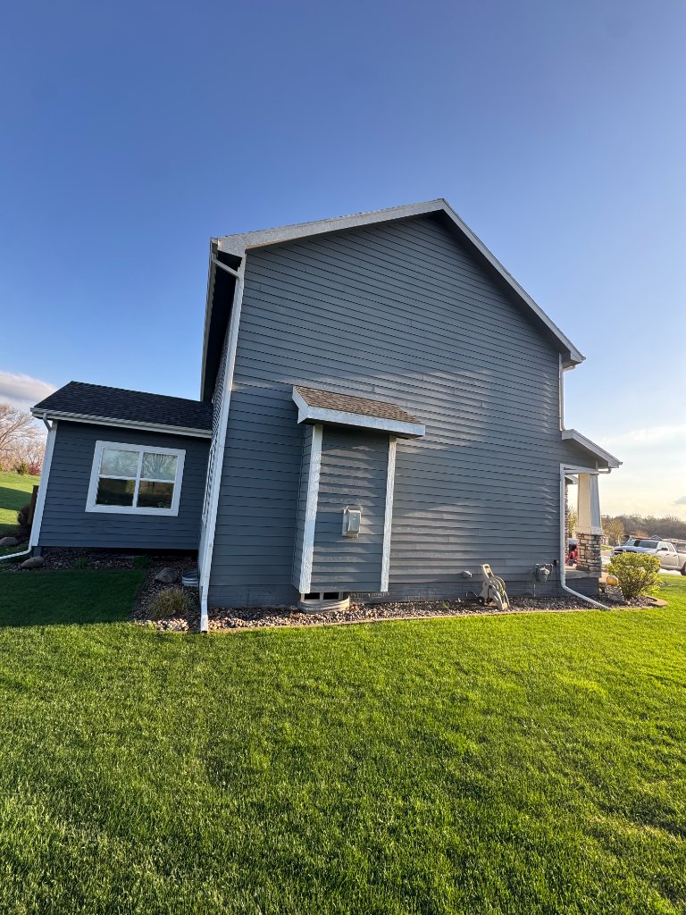 Before - Front corner showing failing Hardie siding