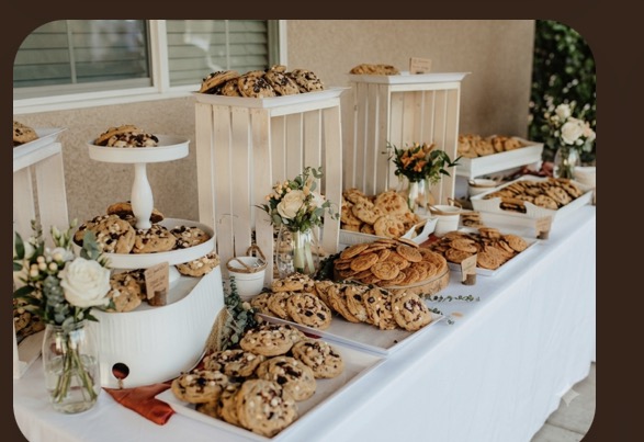 Corporate dessert table styled with trays of fresh cookies