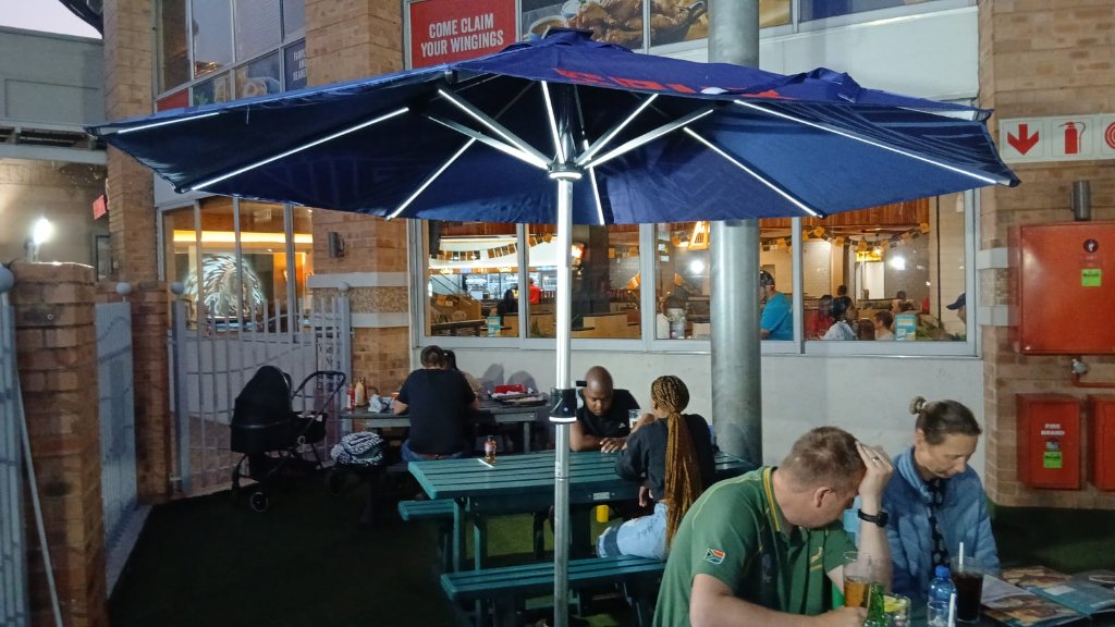 Spur branded umbrella with LED lighting at night