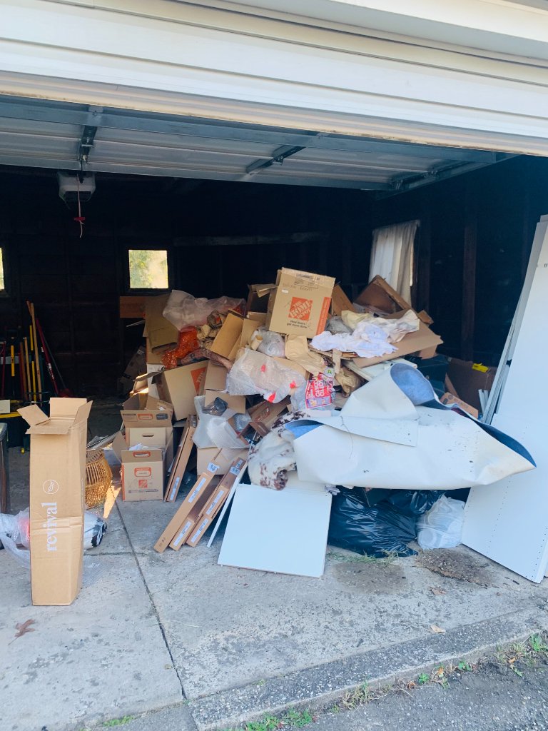 Garage cleanout before - cluttered garage full of junk