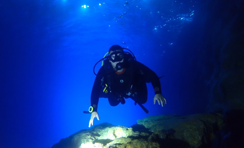 Diver silhouetted against light in the Blue Hole, Gozo