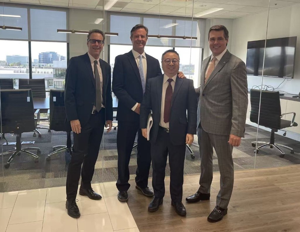Four business professionals in office meeting