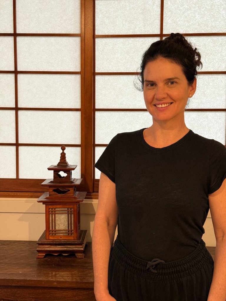 Sammi, therapeutic yoga instructor, with a warm and kind smile