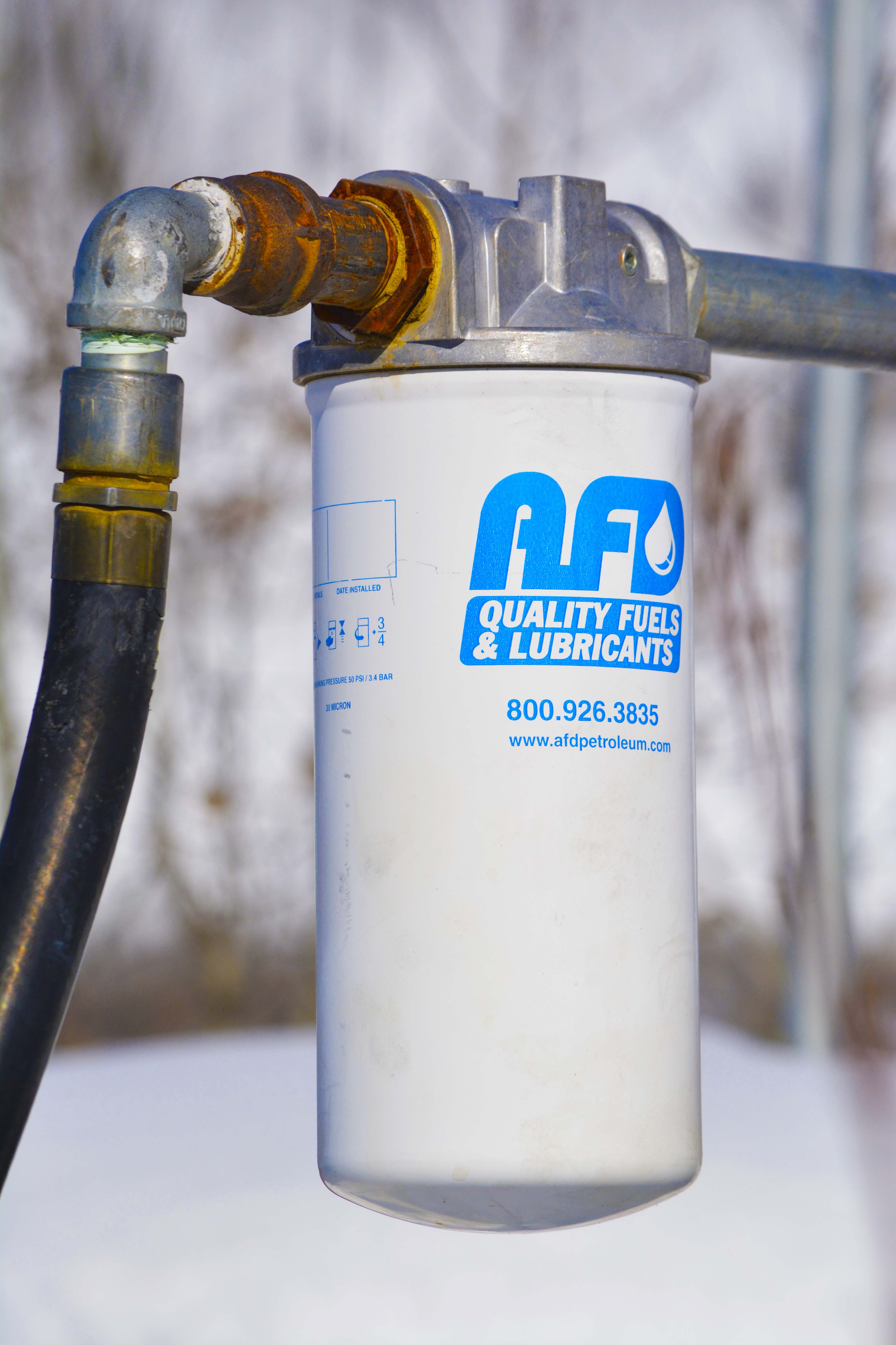 Vertical detail shot of an AFD Petroleum industrial fuel filter unit with branding