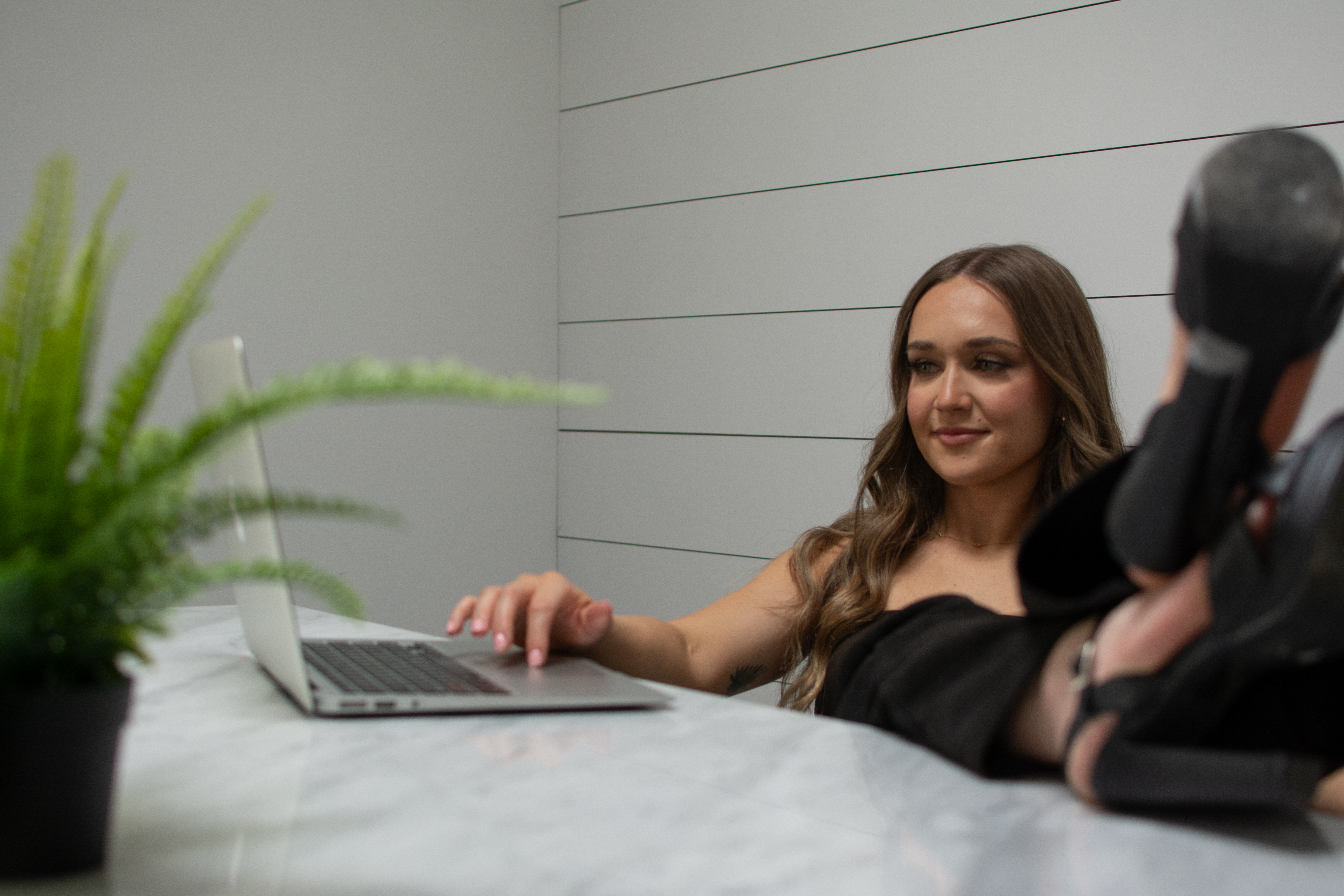 Star Remedy   relaxed desk portrait with heels up on marble