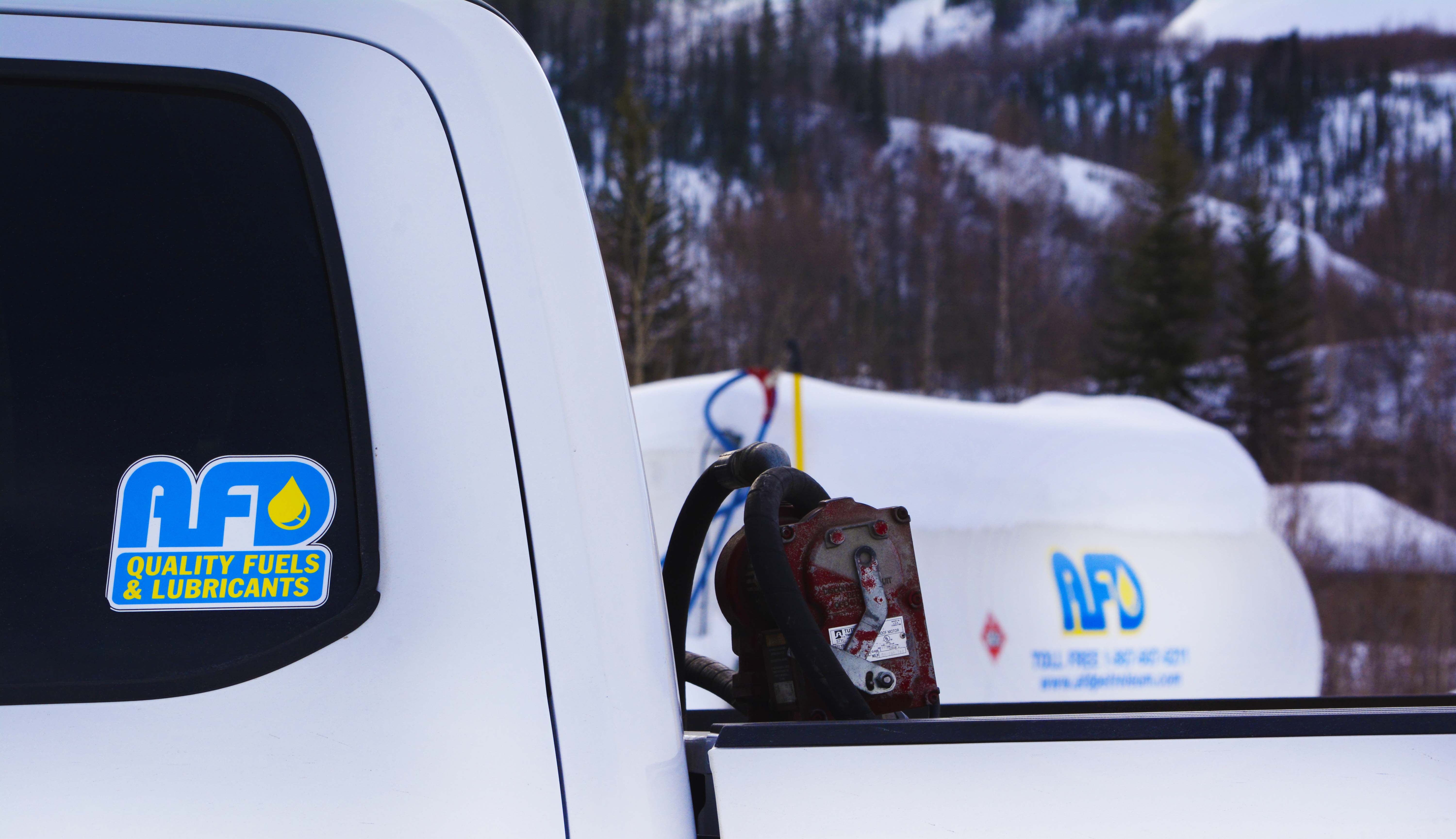 Close-up of AFD Petroleum branding on a vehicle panel beside a fuel pump in the Yukon
