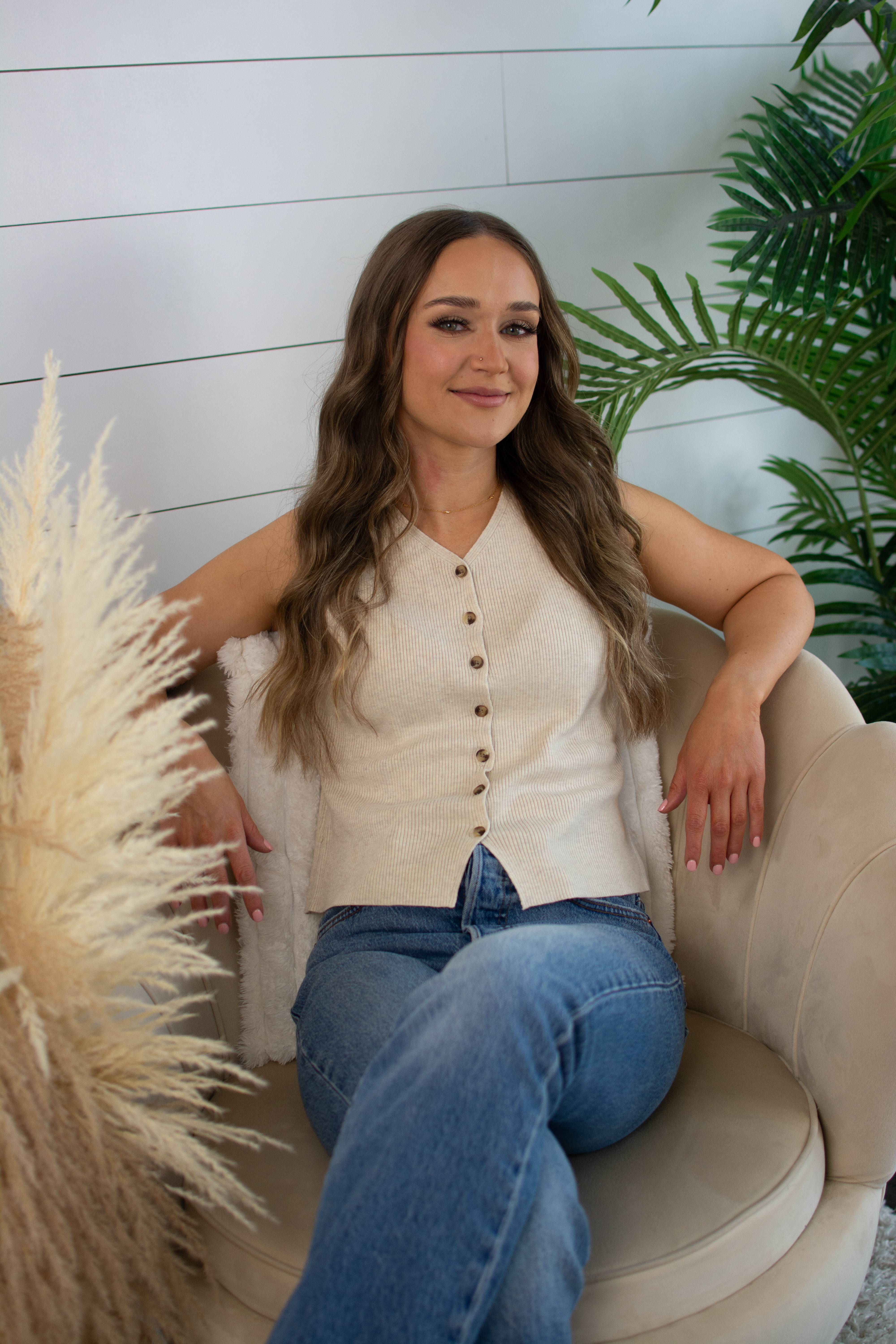 Brand photography — professional on couch with lifestyle plants