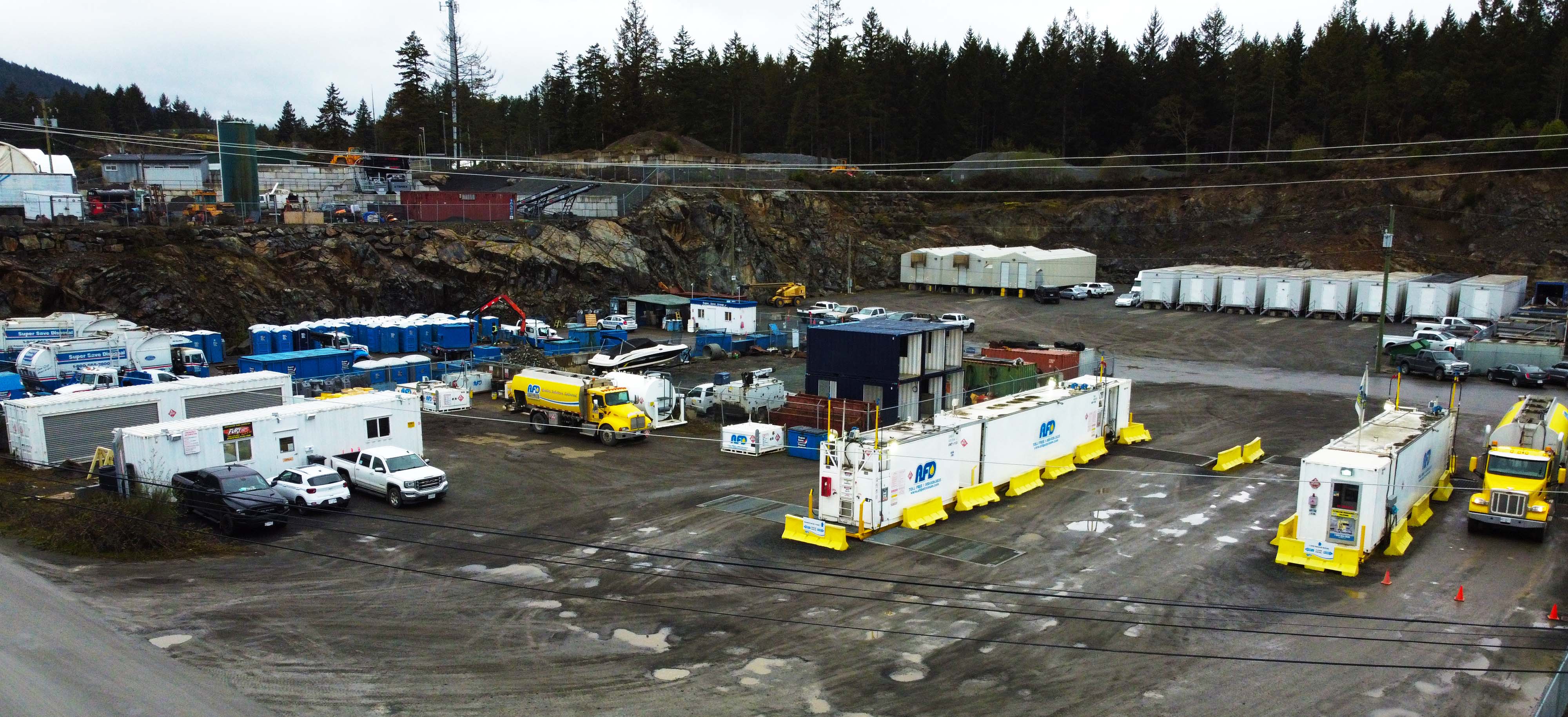 Aerial drone view of the AFD Petroleum Victoria yard with fuel trucks, white trailers and yellow barriers