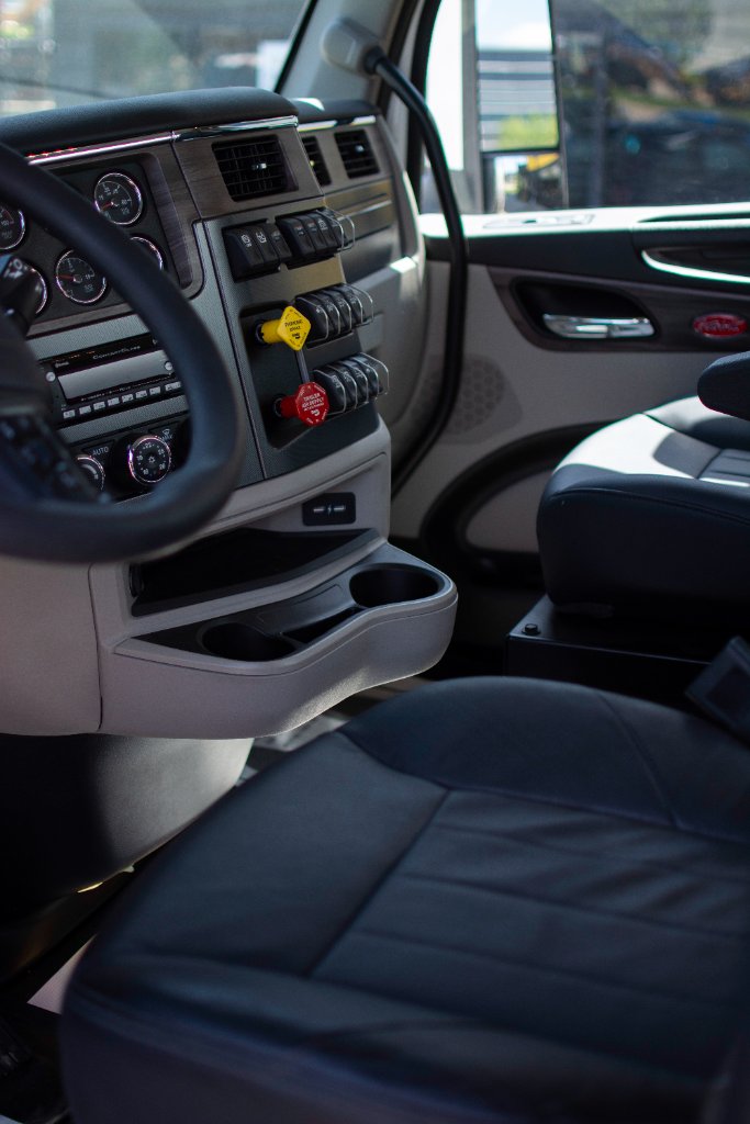Interior shot of truck cab dashboard with air brake controls and instrument cluster