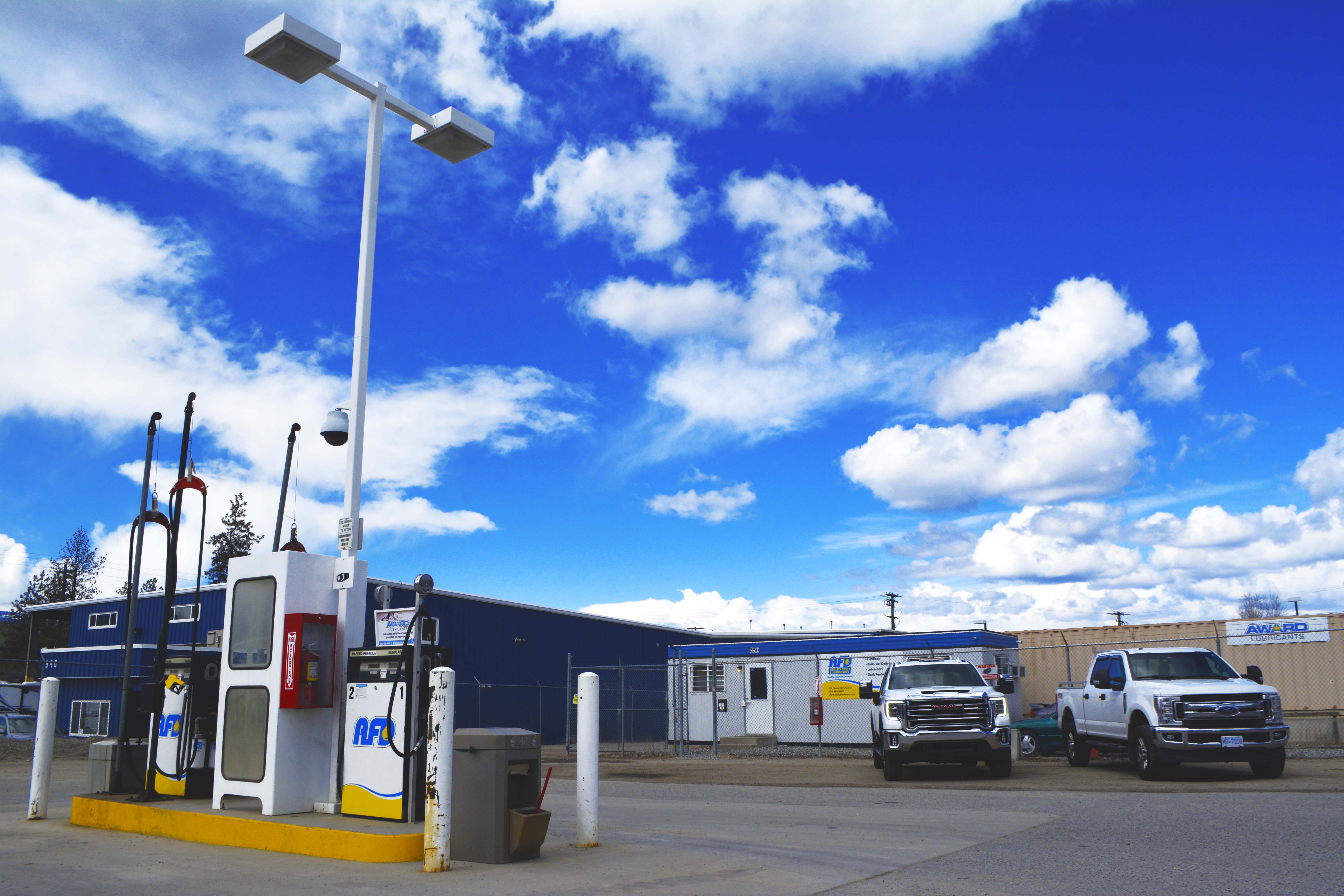 AFD Petroleum fueling island with pumps and parked service trucks at the Kelowna location