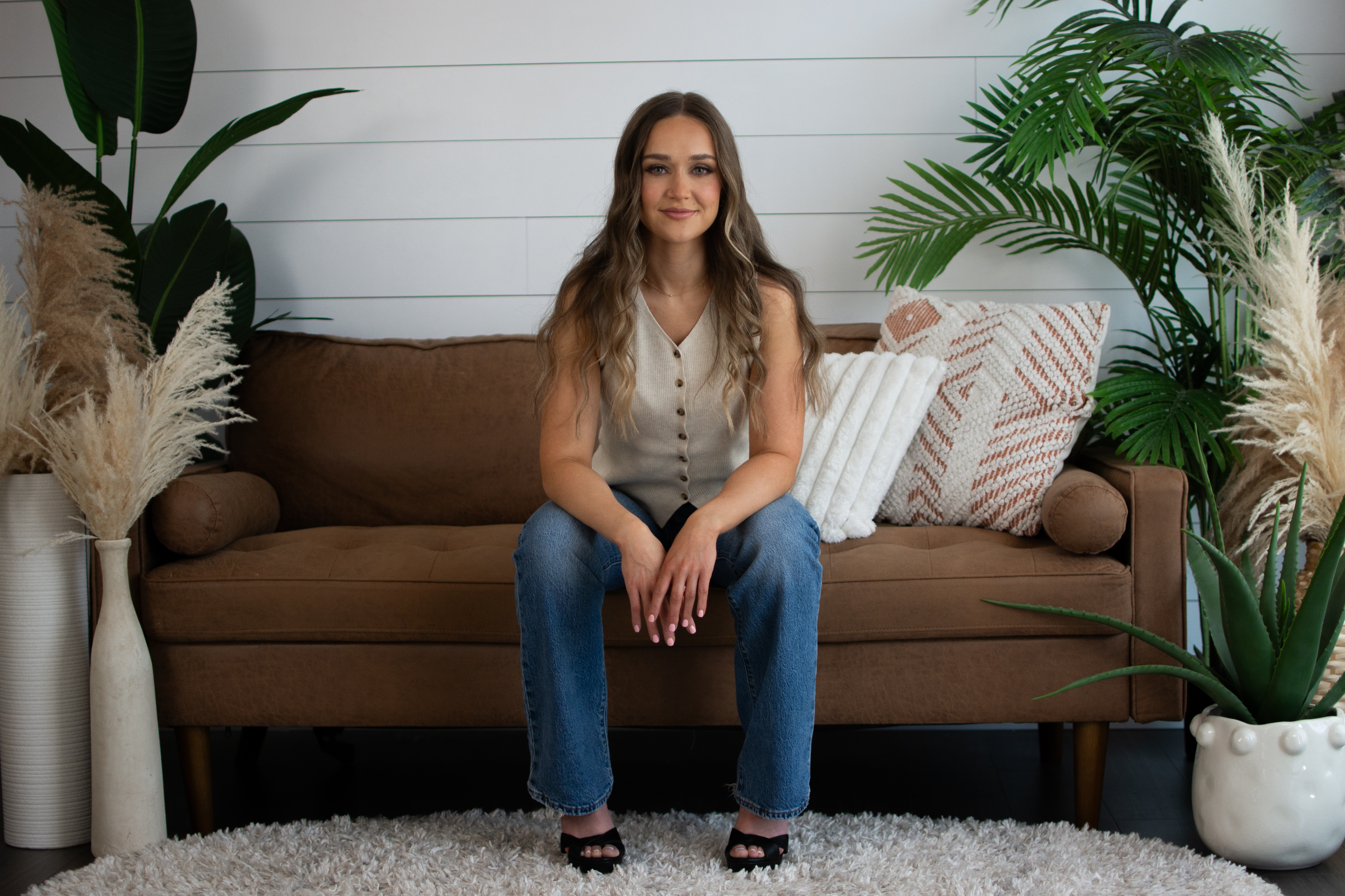 Star Remedy   full seated stool portrait with pampas in foreground