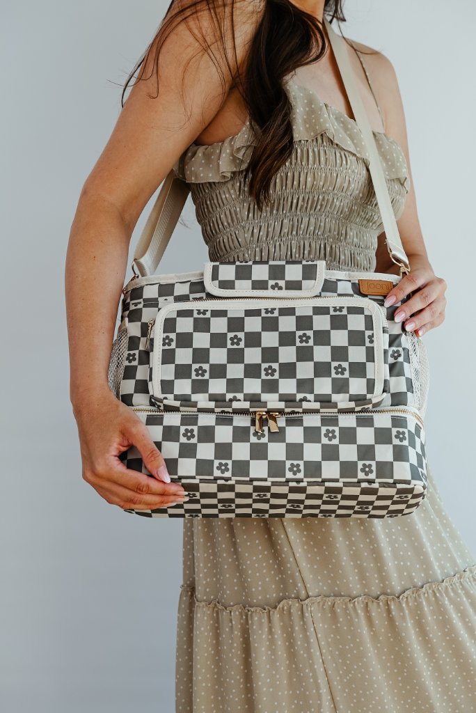 JOONI daisy checker bag held by model