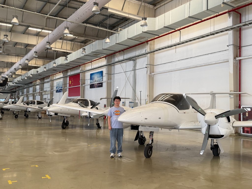Liming standing beside an aircraft at the Diamond Aircraft facility