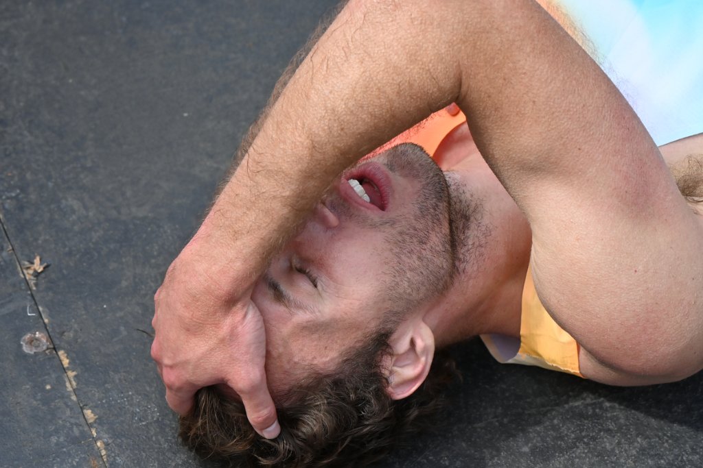 Runner lying on back exhausted after TCS London Marathon 2026