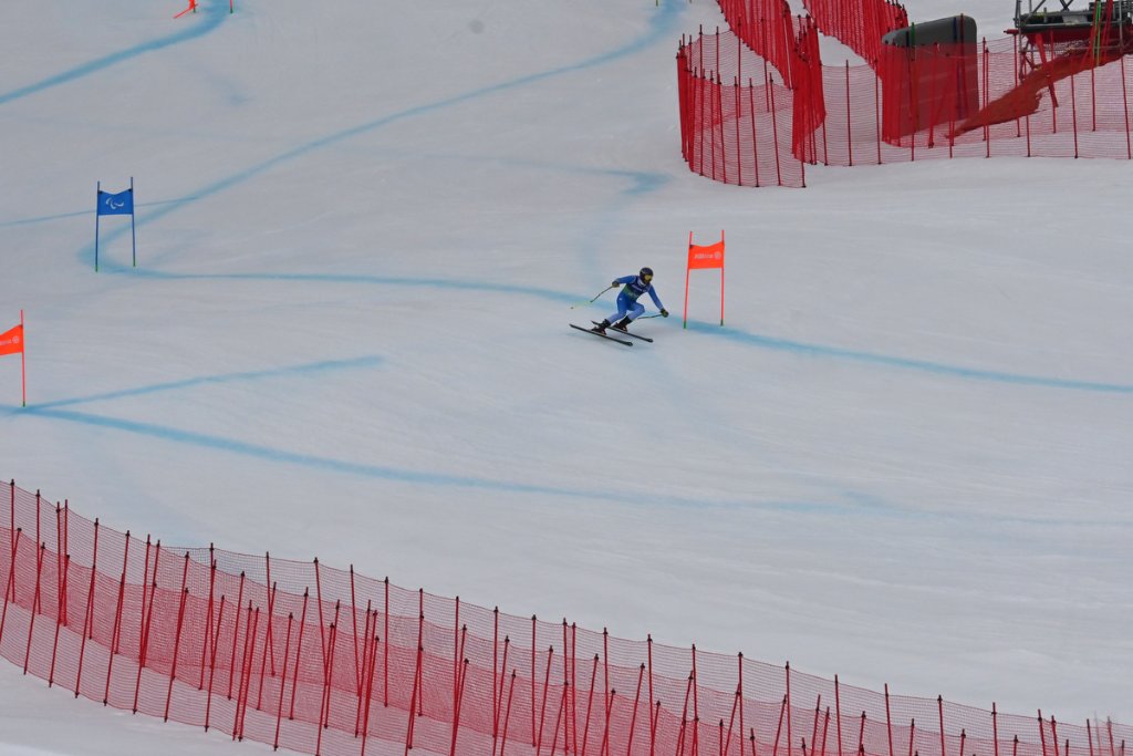 Sit-ski racer at the finish line at Milano Cortina 2026 Winter Paralympics alpine skiing