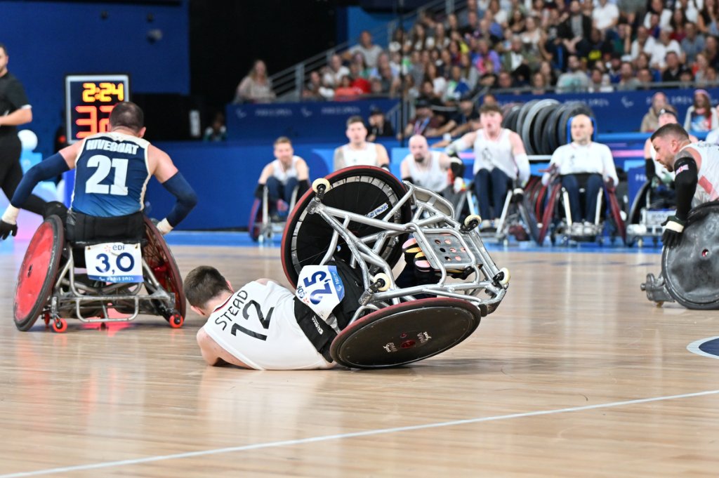 Wheelchair flips during intense GBR vs FRA wheelchair rugby match at Paris 2024 Paralympics