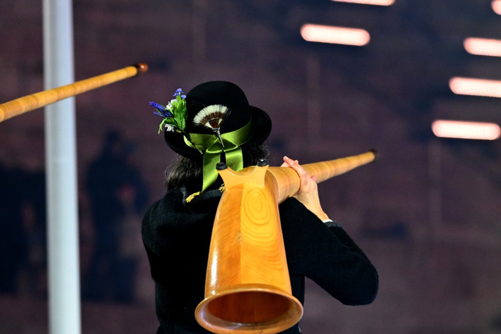 Alpine horn player in traditional hat at the 2026 Winter Paralympics Opening Ceremony