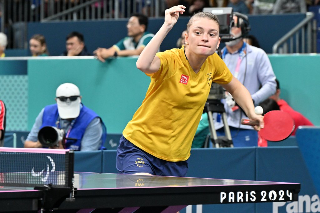 Swedish para table tennis athlete in mid-smash at Paris 2024