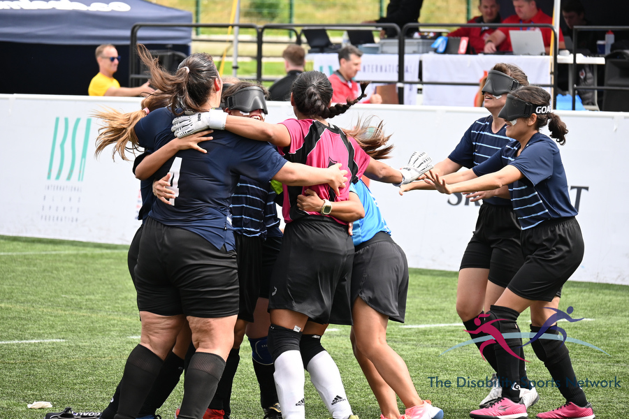 Women's blind football players huddled in celebration during Argentina vs Sweden match